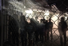 Unaccompanied children line up for an evening meal at a detention facility run by the Greek police. © 2015 Kelly Lynn Lunde